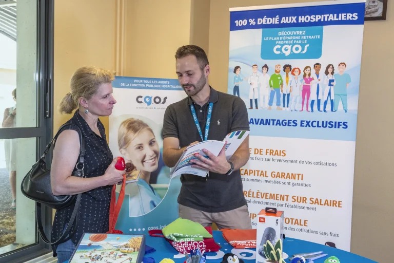 Stand d'animation C.G.O.S en établissement : un conseiller présente la brochure du Plan Épargne Retraite à une agente hospitalière